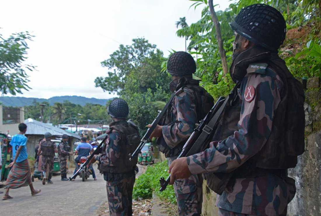 Members of Border Guards Bangladesh (BGB) personnel stand guard along a street at Bandarban on Sept. 19, 2022, during the armed conflict between the military and rebel forces in neighboring Myanmar.