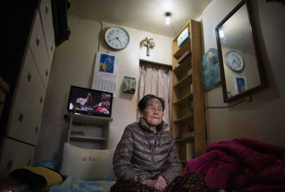 Kim Ok-Soon, 90, sits in her one-room shack in the village of Guryong outside Gangnam in Seoul, South Korea in this file photo