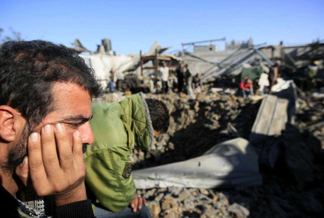 Palestinians check the damage caused by an Israeli air strike on smuggling tunnels in Maghazi refugee camp, central Gaza Strip, in November 2009.