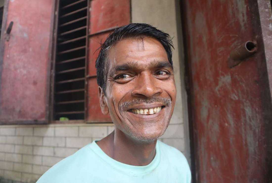 Khokon Rozario poses for a photograph near his house in Gazipur, Bangladesh 