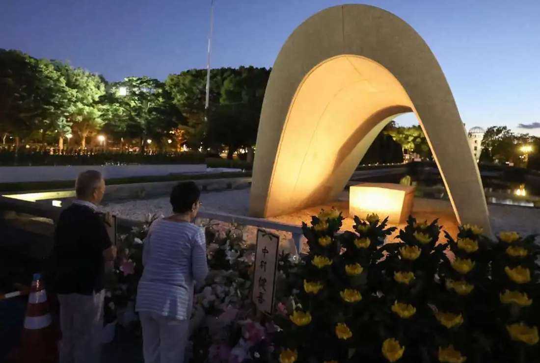People visit and say prayers at sunrise at the cenotaph for the atomic bomb victims at the Peace Memorial Park in Hiroshima on Aug. 6, to mark the 78th anniversary of the world's first atomic bomb attack 