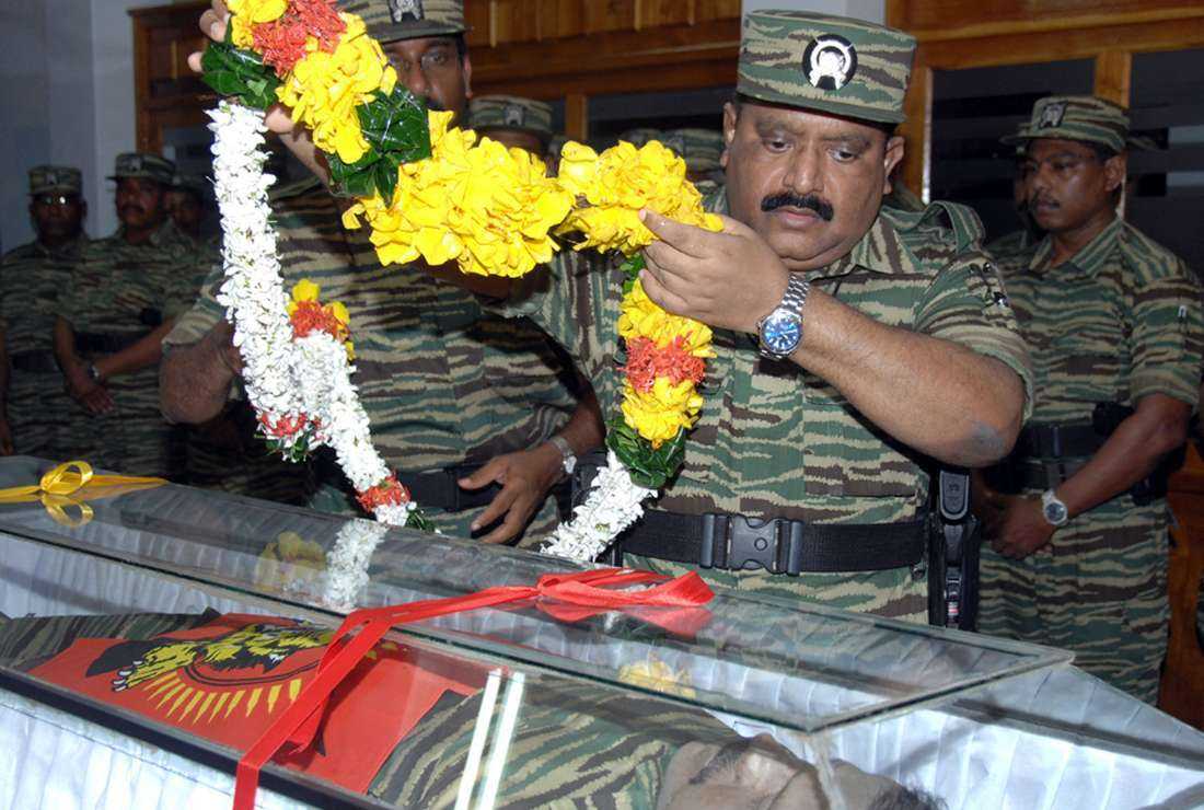 Velupillai Prabakaran, leader of the Liberation Tigers of Tamil Eelam, laying a floral tribute on the body of his senior military commander in northern Sri Lanka on May 21, 2008. Prabakaran was gunned by the Sri Lankan military on May 18, 2009. Honoring the fallen heroes has been a practice started by the armed rebel group.