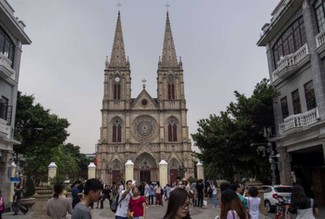 Chinese tourists take pictures in front of the Sacred Heart Cathedral, also known as the Cathedral of the Sacred Heart of Jesus, in Guangzhou, in Guangdong province on September 22, 2018