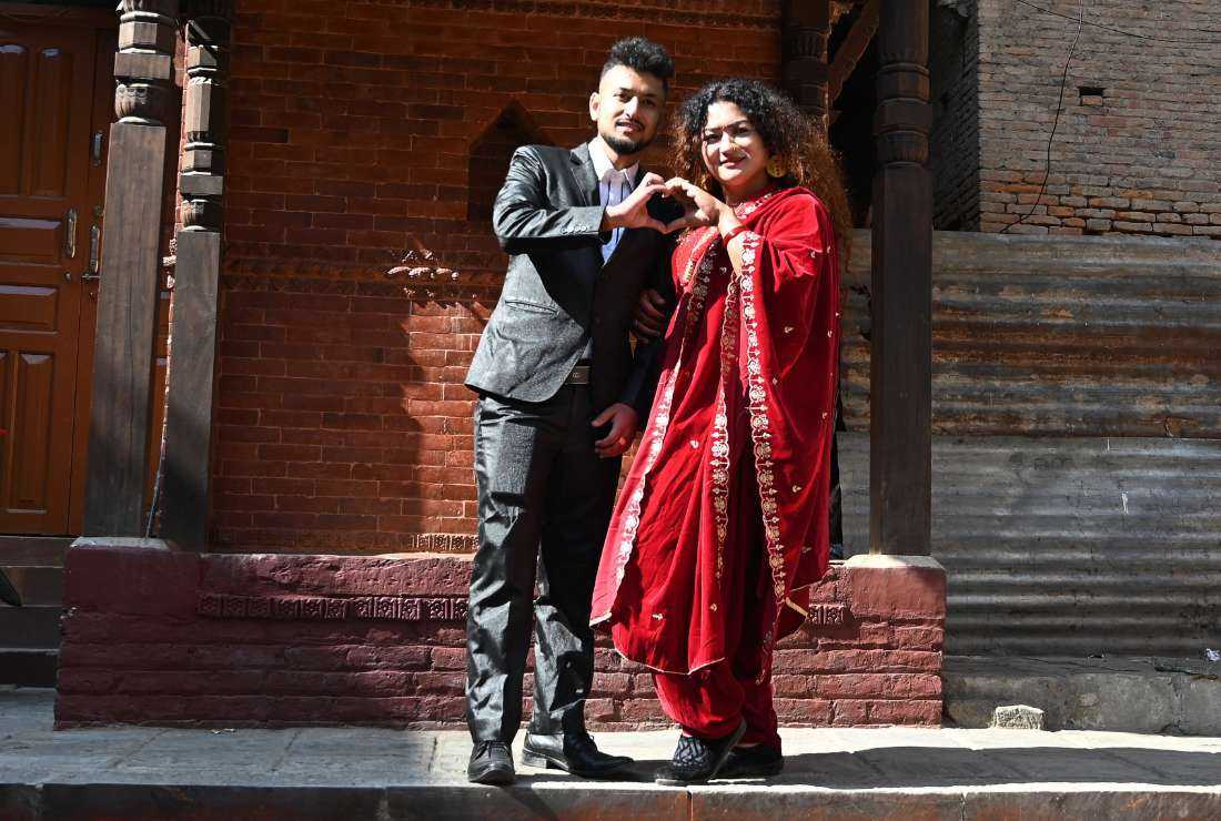 Surendra Pandey (left) and Maya Gurung, a transgender woman, pose for pictures in Kathmandu, Nepal, on Dec. 1 after obtaining their marriage certificate