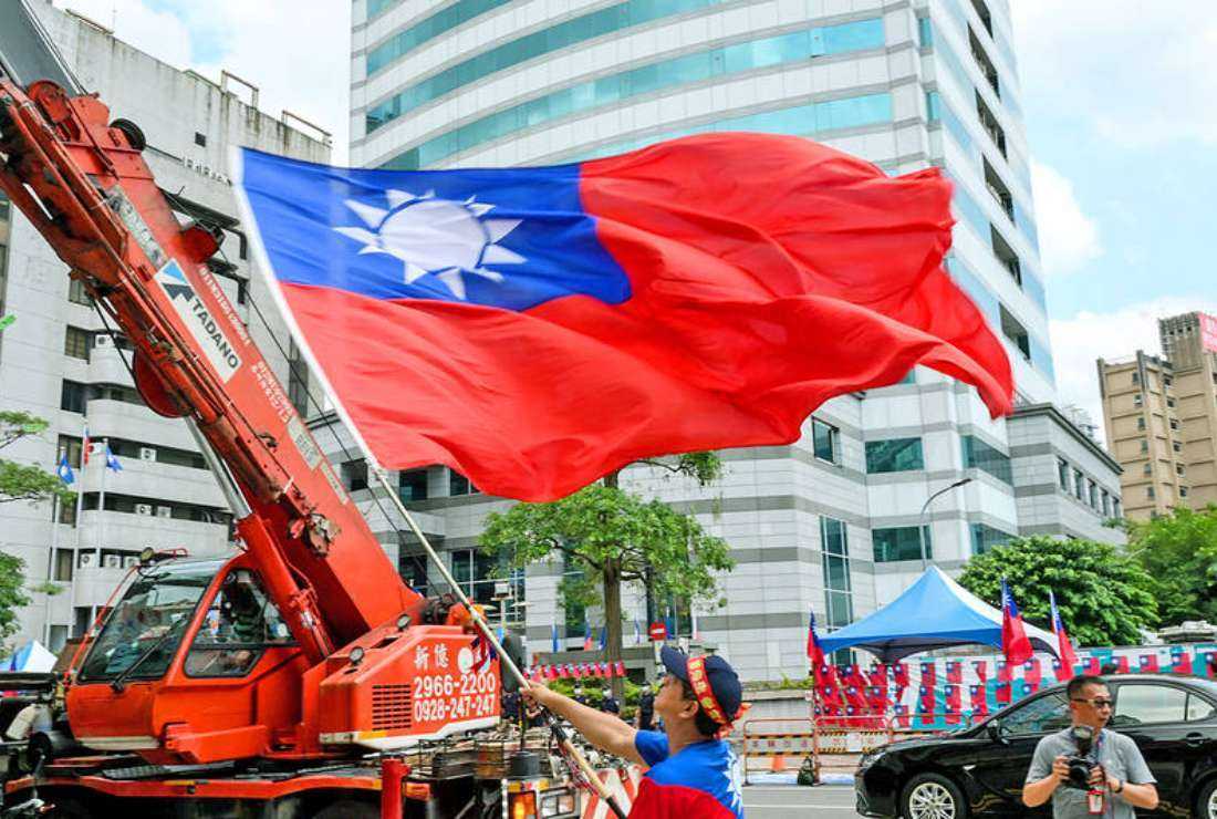 A man waves a Taiwanese flag outside the Chinese Nationalist Party (KMT) headquarters in Taipei on May 17.