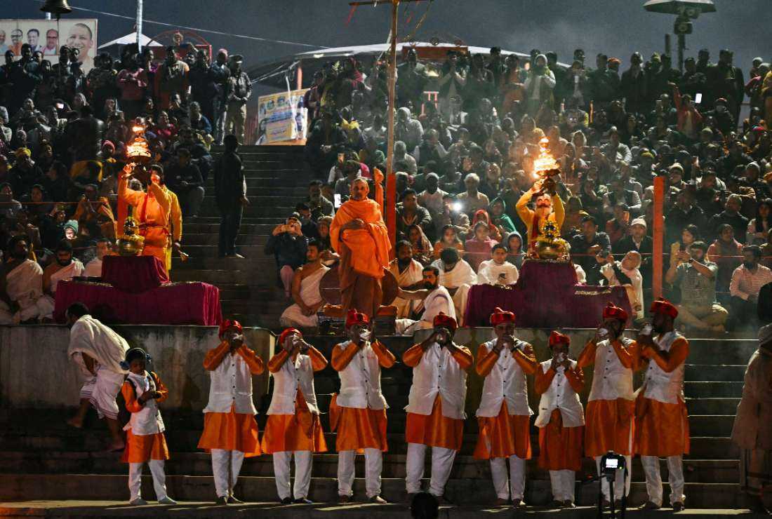 Hindu priests perform evening prayers on the banks of the Sarayu River in the northern Indian state of Uttar Pradesh on December 27, 2023. 