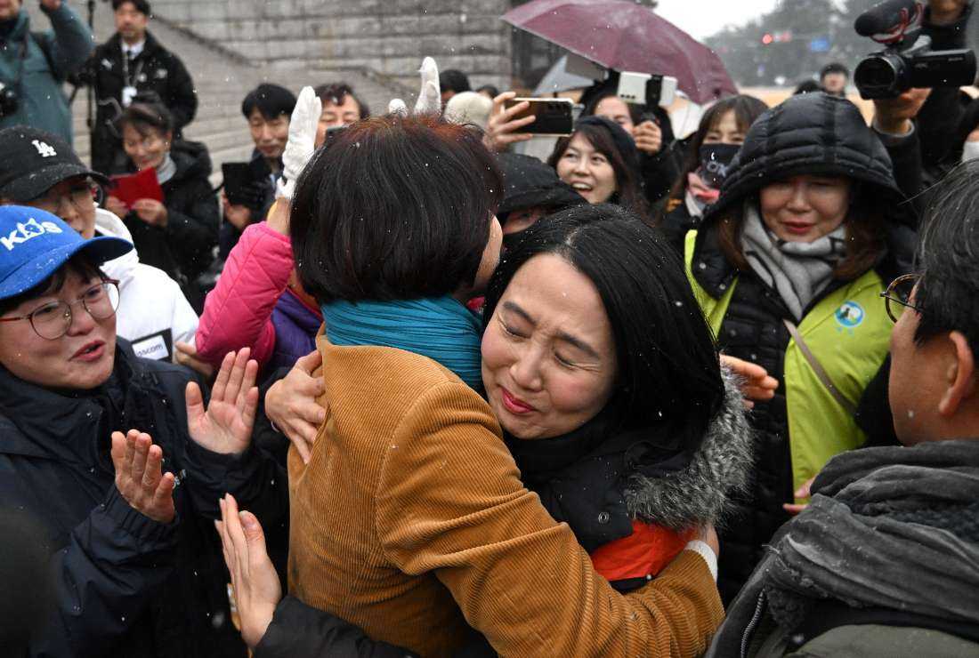 South Korean lawmaker Han Jeong-ae (center left) celebrates with animal rights activists during a rally welcoming a bill banning dog meat trade at the National Assembly in Seoul on Jan. 9. 