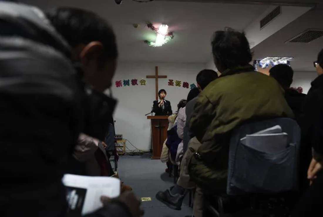 A pastor of an underground church conducts a Christmas Eve service at an apartment in Beijing on Dec. 24, 2014.