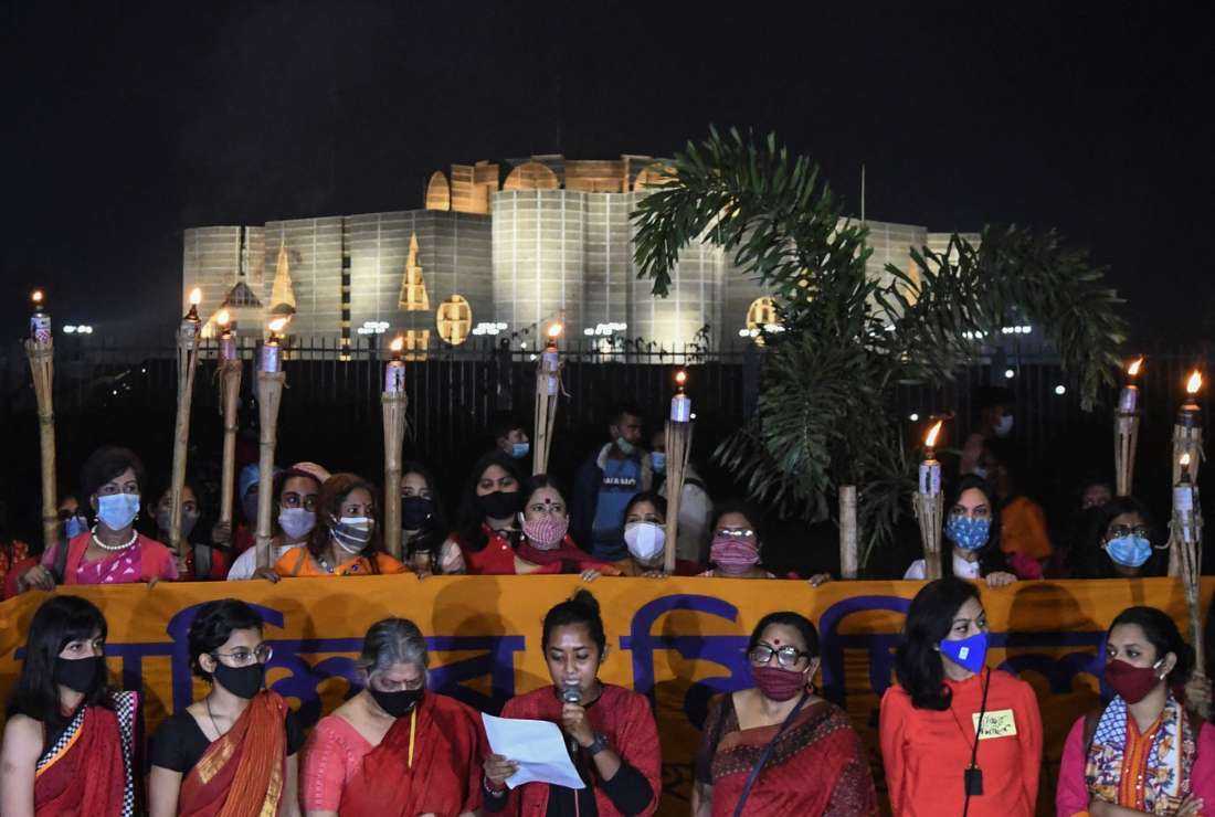 Social activists read a manifesto in front of the Parliament House of Bangladesh during a protest against an alleged rape and torture of a woman, in Dhaka on Nov. 25, 2020. Religious and ethnic minorities are the most vulnerable as a result of eroding democratic institutions and organized violence under political patronage directed against them in the Muslim majority nation. 