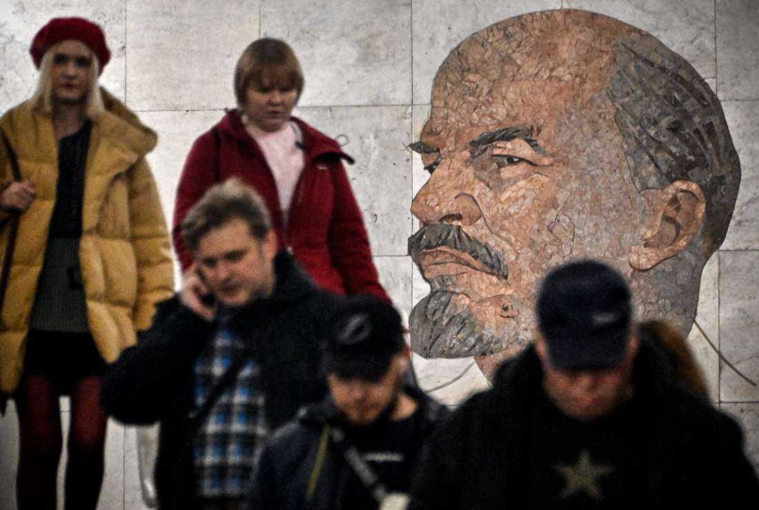 Commuters pass by a mosaic portrait of the Soviet Union founder Vladimir Lenin, creat by Soviet artist Grigory Opryshko in 1965, at a metro station in Moscow on Nov. 1, 2023.