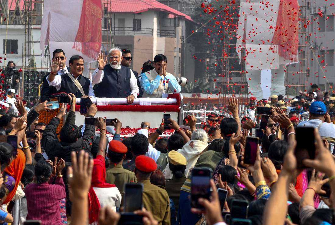 Prime Minister Narendra Modi (center) along with Chief Minister of Assam Himanta Biswa Sarma (center, left) waves to supporters during a public rally in Guwahati on Feb. 4.