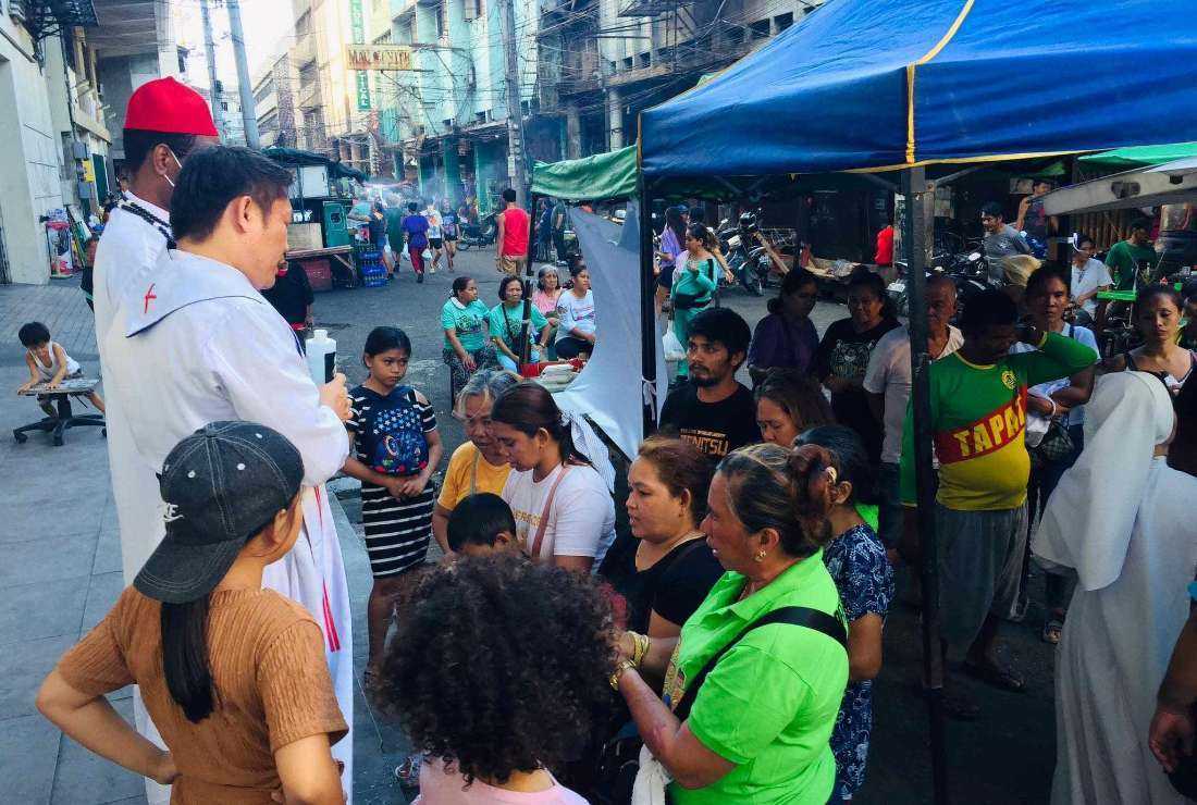 Catholic religious speak to people on the streets during a weeklong promotional activity to step up the vocation initiatives of the Church at the Freedom Park-Carbon Public Market in Cebu, Philippines, from Feb. 5 to 10.