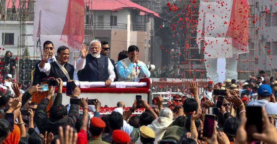 Prime Minister Narendra Modi (center) along with Chief Minister of Assam Himanta Biswa Sarma (center, left) waves to supporters during a public rally in Guwahati on Feb. 4.