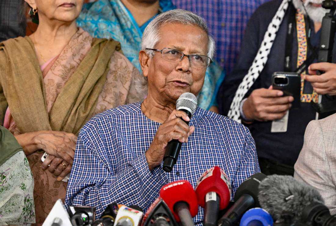 Bangladesh Nobel peace laureate Muhammad Yunus (center) addresses a press conference at his office in Dhaka on Feb. 15