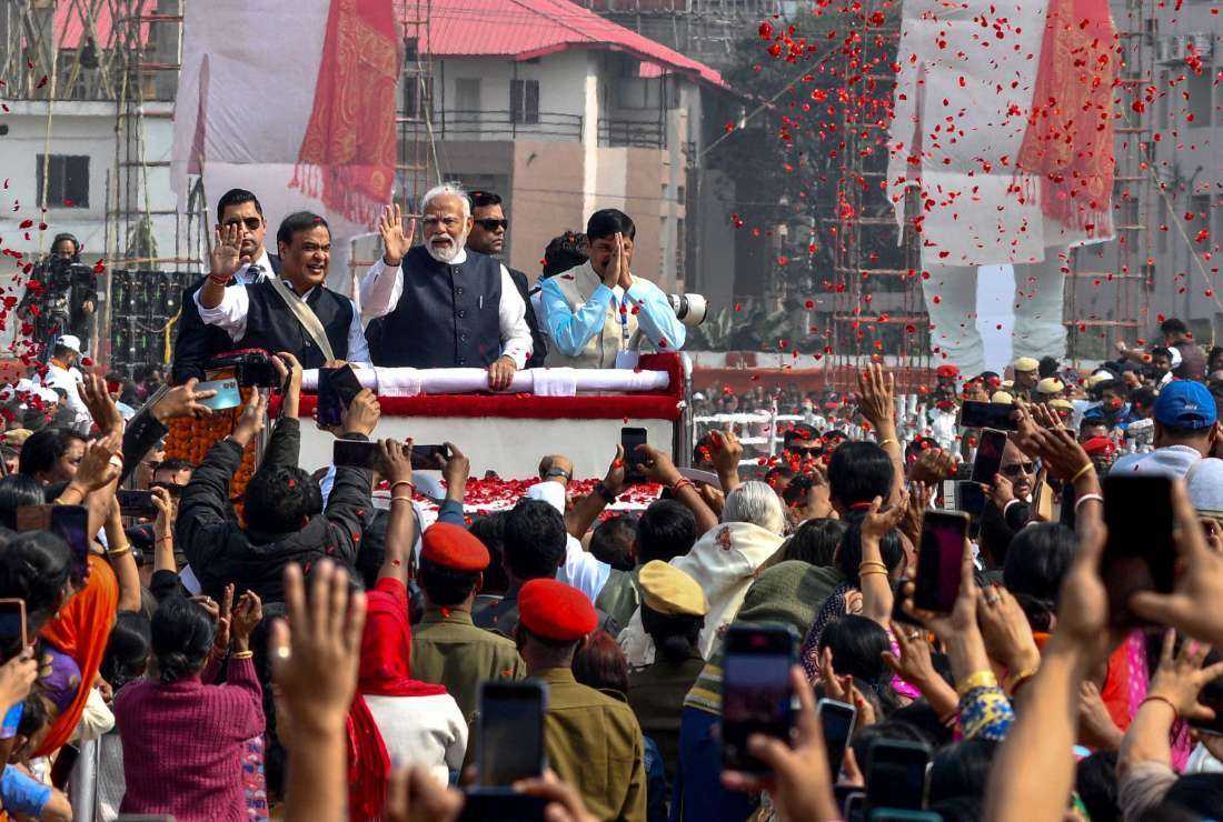 India's Prime Minister Narendra Modi (center) waves to supporters during a public rally in Guwahati on Feb. 4.