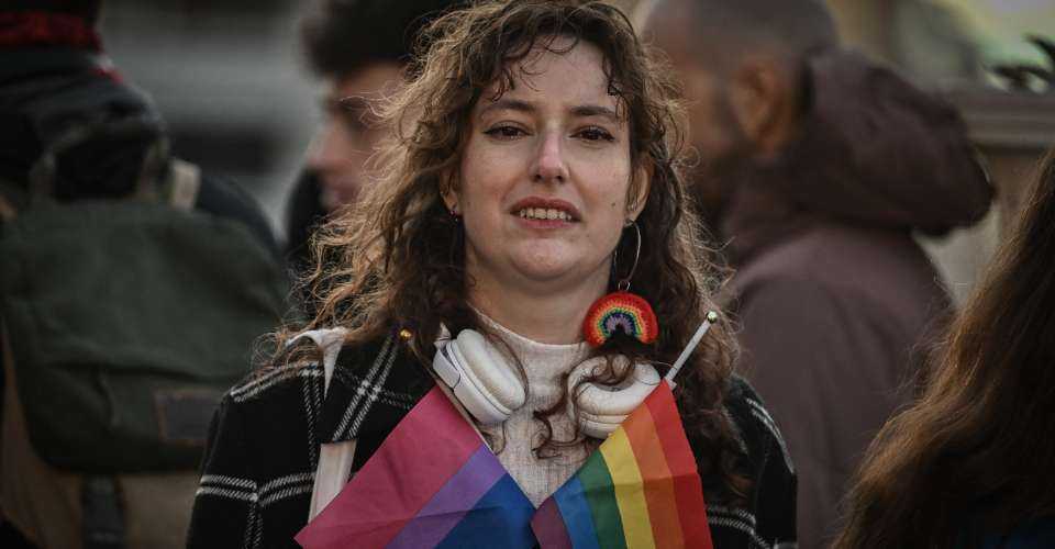 A person gathers with fellow LGBTQ community members outside the Greek Parliament as lawmakers vote on same-sex marriage and adoption for same-sex couples bill on Feb. 15 in Athens. Greece's Parliament was set to legalize same-sex marriage and adoption today, a landmark reform promoted by the conservative government over the opposition of the country's powerful Orthodox Church. 