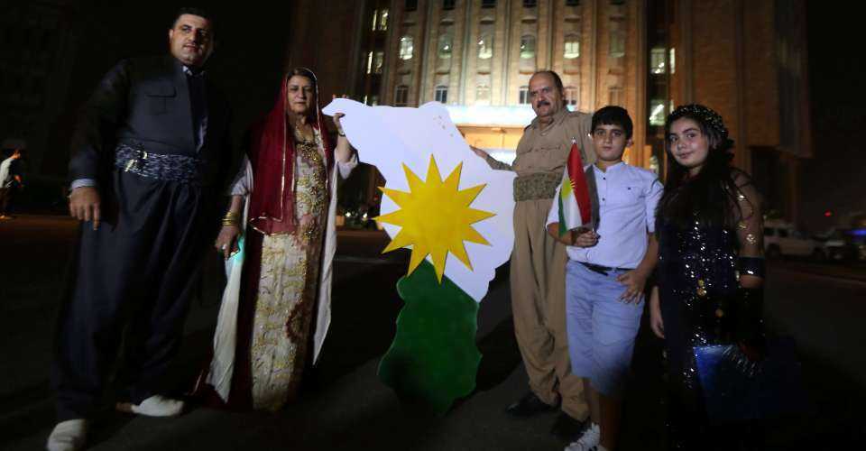 Iraqi Kurds stand outside Kurdistan's parliament building in Erbil, capital of the autonomous Kurdish region of northern Iraq, Sept. 15, 2017. Christian political parties have announced boycott of upcoming regional elections in June to protest the Iraqi top court's decision to abolish quota seats allocated for minorities.
