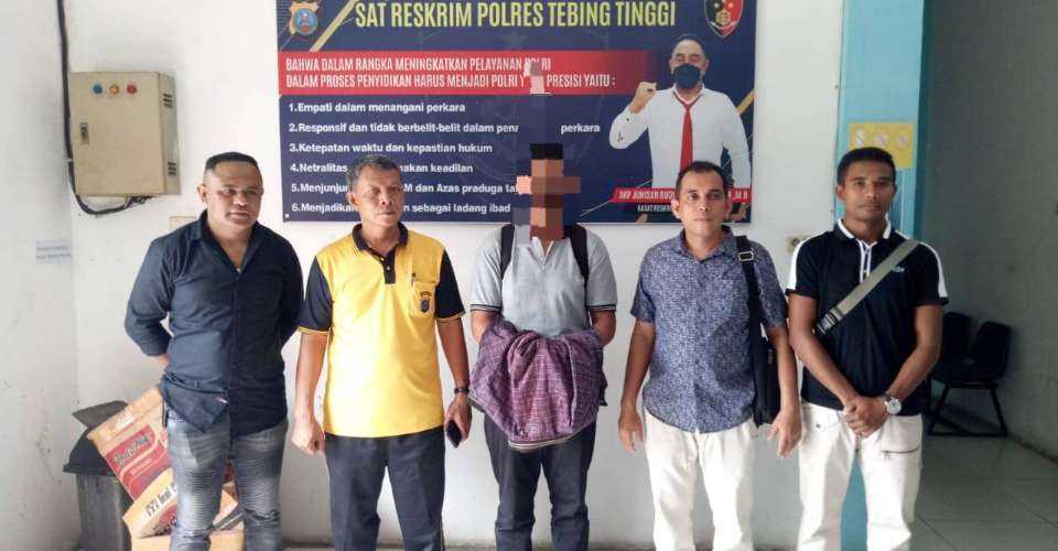 Engelbertus Lowa Soda (center), is seen with police before departing from North Sumatra to Flores Island of Indonesia on March 2 following his arrest.