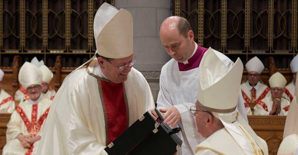 In this photo taken and released on July 28, 2022, by the Vatican press office, Pope Francis (right) and the Archbishop of Quebec, Cardinal Gérald Cyprien Lacroix, celebrate Mass at the National Shrine of Sainte-Anne-de-Beaupré in Quebec, Canada.
