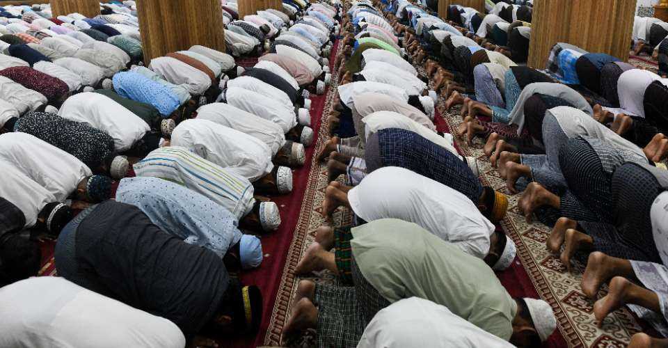 Muslims offer morning prayers to mark the Islamic festival of Eid ul-Fitr in Yangon on April 22, 2023. The Myanmar military has dispatched Muslim conscripts to fight fellow Muslims opposed to the ruling junta in the Southeast Asian nation’s west