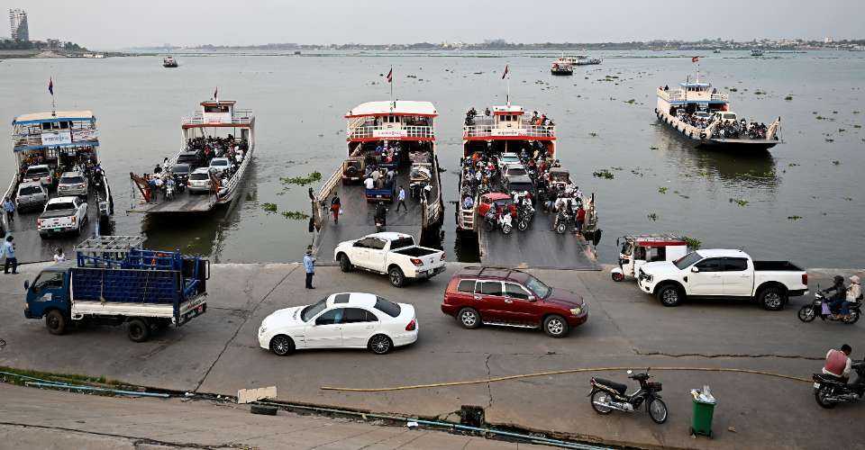 Ferries transport passengers and vehicles across the Mekong River in Phnom Penh on April 9. The $1.7-billion Funan Techo Canal project will link Phnom Penh with the coastal province of Kep.