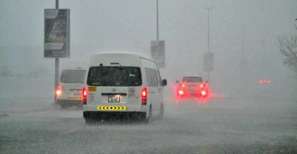 Vehicles drive on a flooded road during torrential rain in the Gulf Emirate of Dubai on April 16. 
