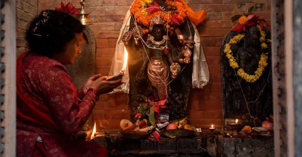 A devotee performs a prayer ritual in front of the sculpture of a Hindu god that was reinstalled in Patan on the outskirts of Kathmandu in this file image.
