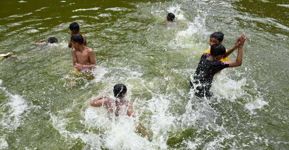 Children swim in a pond during a heatwave in Bangladeshi capital Dhaka on April 17.