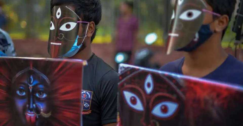 Activists wearing masks depicting Hindu goddess Kali hold placards during a protest against religious violence against the Hindu community in Bangladesh, in Dhaka on Nov. 4, 2021. 