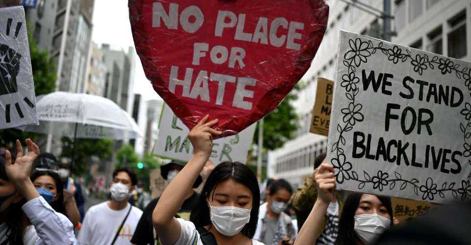 People take part in a Black Lives Matter protest march in central Tokyo on June 14, 2020. Discrimination in Japan today is often subtle yet insidious, affecting opportunities for employment, marriage, and social integration for certain groups.
