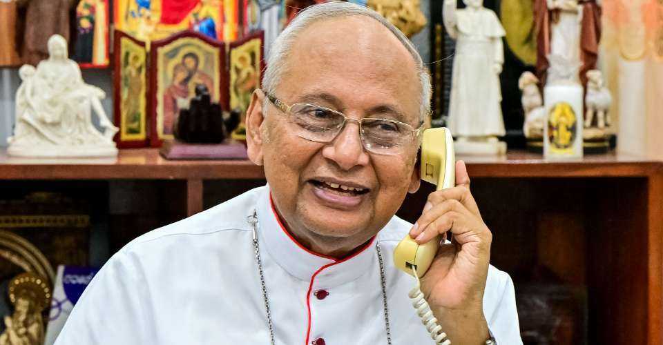 Cardinal Malcolm Ranjith uses his cellular phone during a media interview in the Archbishop House in Colombo on April 17.