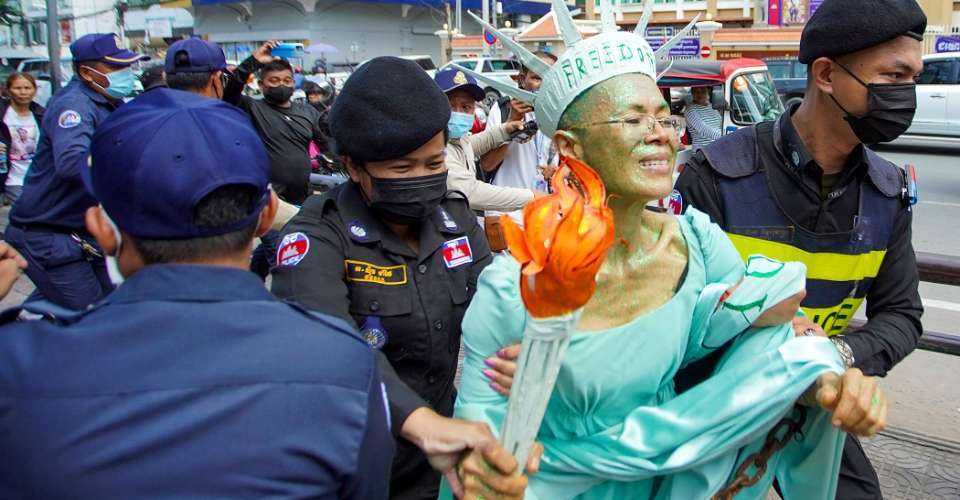 Cambodian-US human rights advocate Theary Seng, dressed as Lady Liberty, is arrested by police after being found guilty of treason in her trial in front of the Phnom Penh municipal court on June 14, 2022.