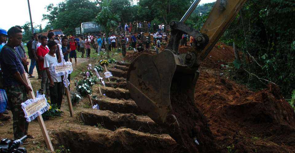 Heavy construction equipment is used to dig graves as a mass funeral takes place to bury victims of a military strike on a camp for displaced people near the northern Myanmar town of Laiza on Oct 10, 2023. Myanmar’s opposition National Unity Government (NUG) has urged a united political front among a patchwork of ethnic armies after a five month dry-season offensive resulted in unprecedented battlefield gains.
