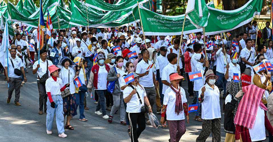 Workers hold banners and flags as they march along a street to mark the International Labour Day in Phnom Penh on May 1. Morm Rithy who was arrested on May 7 was a prominent speaker during commemorations to mark the Labour Day.