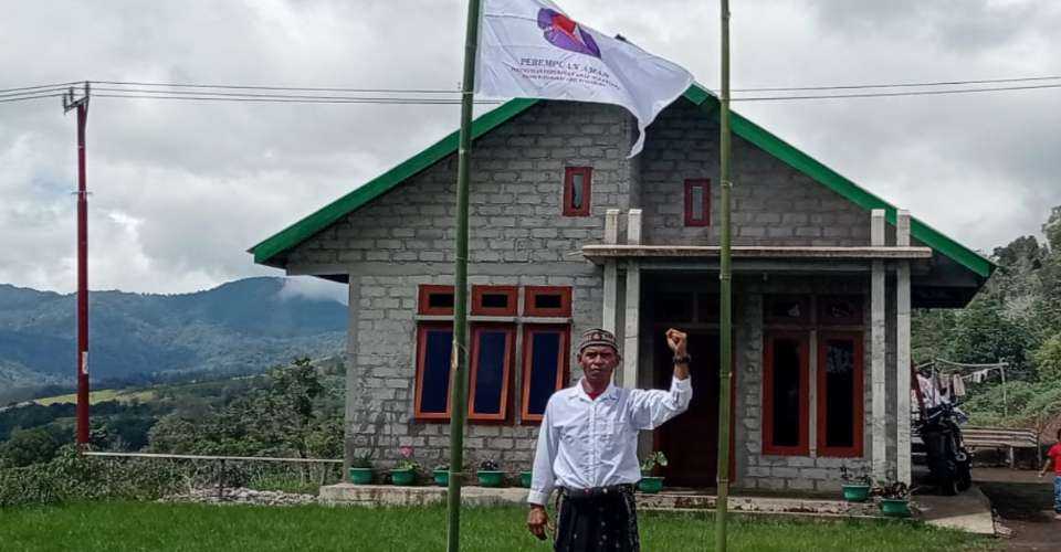 Mikael Ane stands in front of his house on a site claimed by the government as part of the Ruteng Natural Tourism Park. 