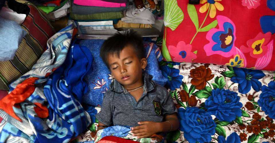 A child takes a nap inside a relief camp in Manipur on July 25, 2023. There is no end in sight to the one-year-old violence in the northeastern state.