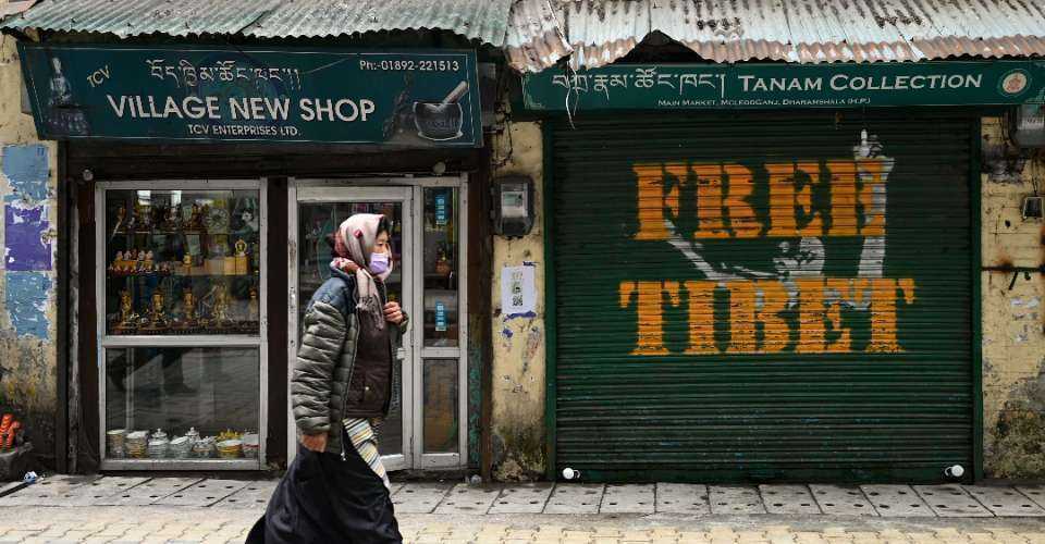 A woman walks past a closed shop with the message 'Free Tibet' written on it, in McLeod Ganj near Dharamsala in India on Feb. 20.