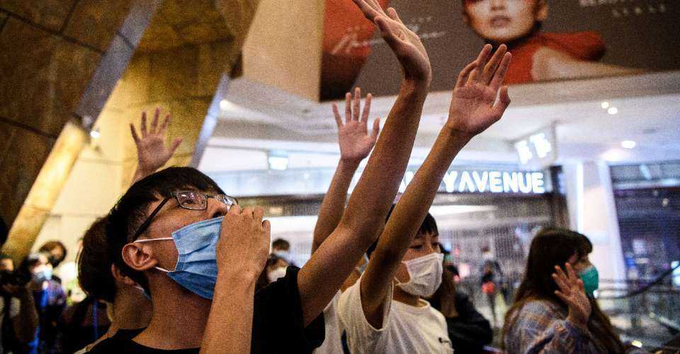 This photo taken on May 13, 2020, shows anti-government protesters singing the protest anthem Glory to Hong Kong as they gather in a shopping mall in Hong Kong.
