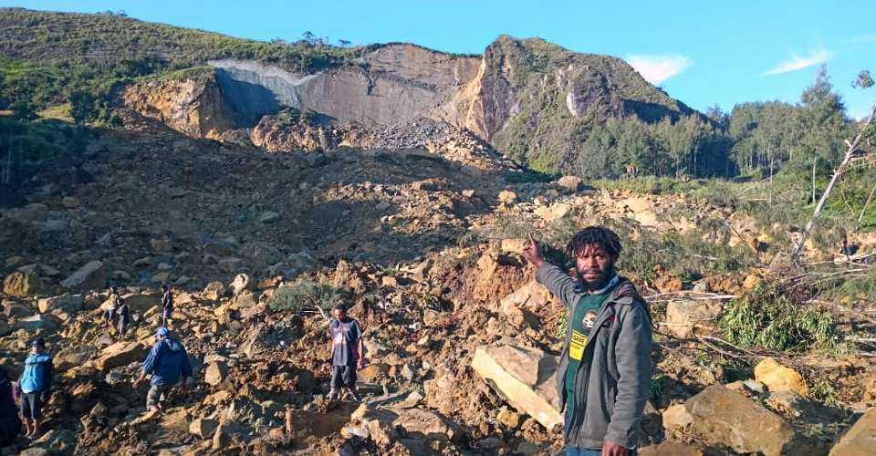 People gather at the site of a landslide in Maip Mulitaka in Papua New Guinea's Enga Province on May 24, 2024.