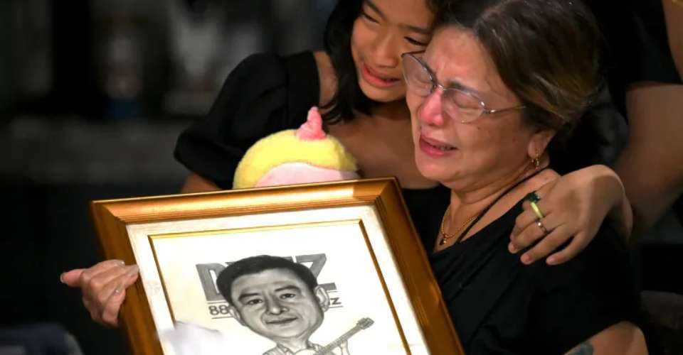 Family members grieve the loss of Filipino journalist Percival Mabasa at their home in Las Pinas in this file image. 