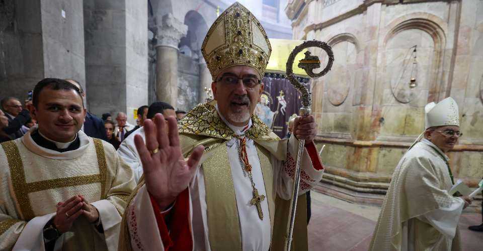 Latin Patriarch of Jerusalem Pierbattista Pizzaballa (center) arrives to lead a mass at the Church of the Holy Sepulchre in the Old City of Jerusalem, during the celebration of Easter Sunday on March 31. 