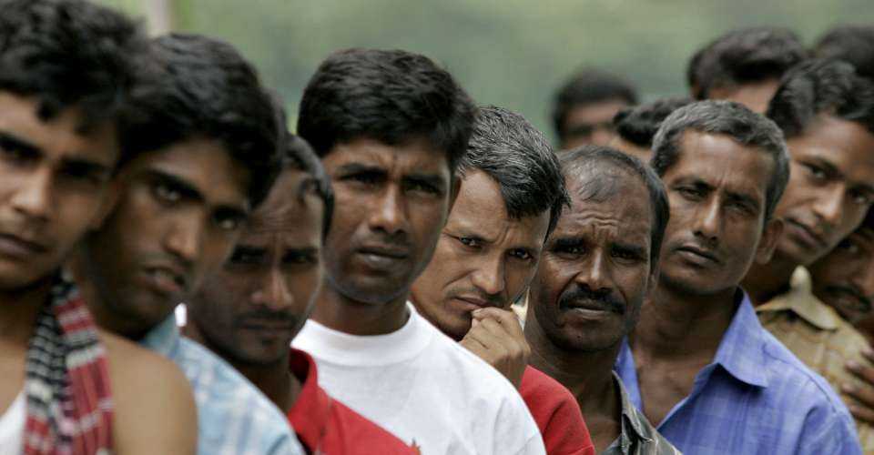 A file picture of Bangladeshi migrant workers waiting in line for food donated by a goodwill charity group for Christmas outside the Bangladeshi High Commission in Kuala Lumpur, Malaysia.