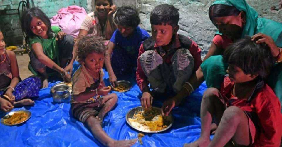 Jaimala Devi, mother-of-seven, feeds her children in her village house in India's Bihar state. The Rashtriya Swayamsevak Sangh, the parent organization of Modi’s party, is against missionary work in the country.