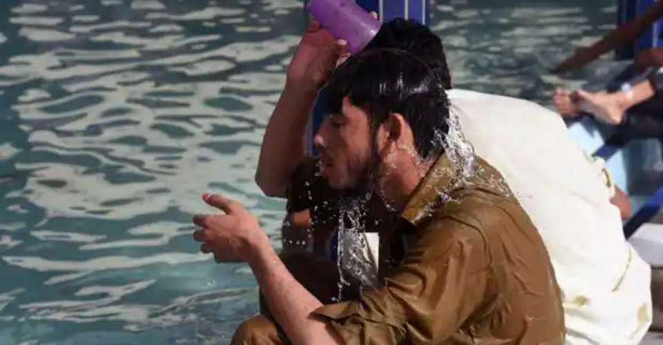 A man takes a shower amid a deadly heat wave in Pakistan that has reportedly left hundreds dead. 