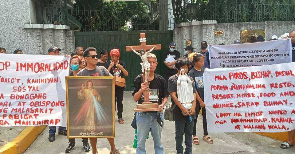 Lay Catholics join a prayer rally in front of the Apostolic Nunciature in Manila, Philippines, as part of what they call a campaign against 'corrupt practices' in Lucena Diocese, on June 18.