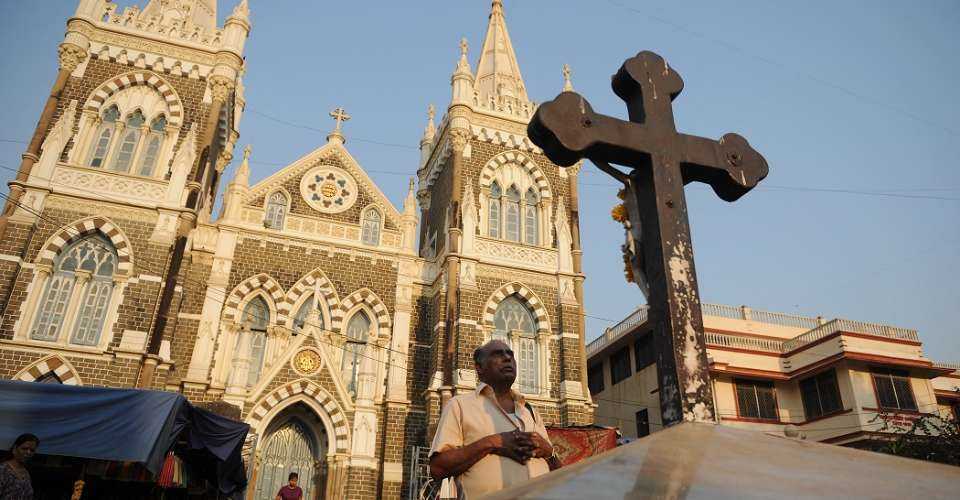 An Indian Catholic man prays outside the Mount Mary Church in Mumbai in this file photo. Court cases involving Catholic and Protestant dioceses in Mumbai has prompted calls for a new national law to manage Church properties. 