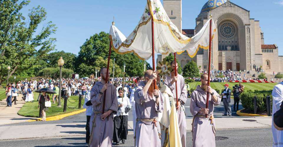 The faithful depart the Basilica of the National Shrine of the Immaculate Conception June 8 as they follow the Blessed Sacrament in procession through the streets of the Brookland neighborhood of Washington, D.C.
