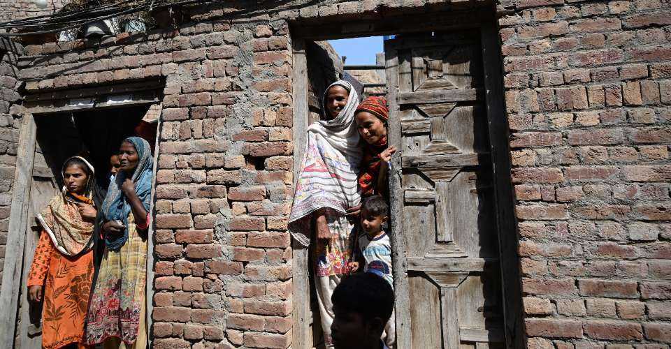 Christians stand at the door of their newly reconstructed houses in Jaranwala on Oct. 12, 2023. More than 80 Christian homes and 26 churches were vandalized in a riot in Jaranwala in Punjab province on Aug. 16, 2023. 