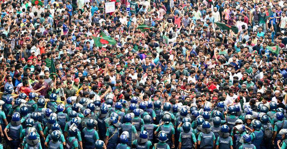 Students scuffle with police during a protest to demand merit-based system for civil service jobs in Dhaka on July 11, 2024.