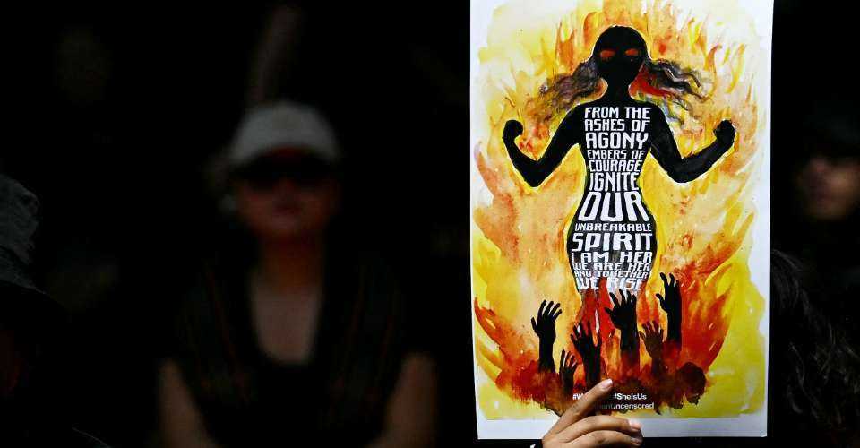 A protestor from a tribal community holds a placard during a demonstration in New Delhi on May 4 to mark a year of the ongoing ethnic conflict in the remote northeastern state of Manipur.